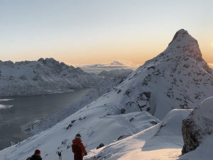 Two people on a snowy mountain in Lofoten, Norway