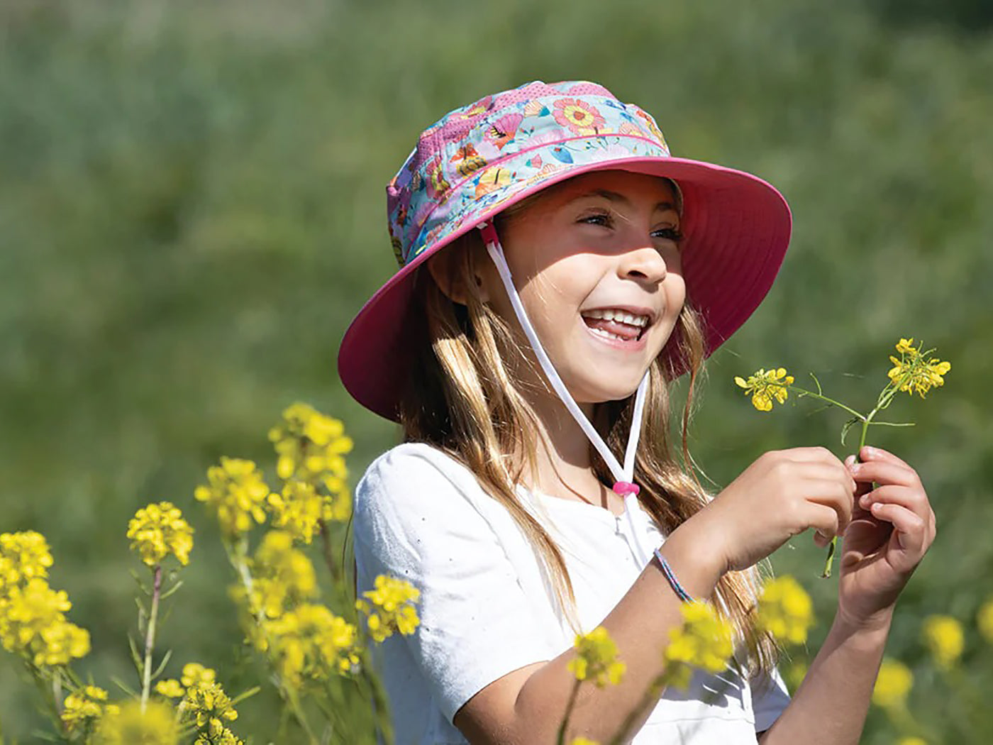little girl wearing a Sunday Afternoons Pollinator Kids' Fun Bucket