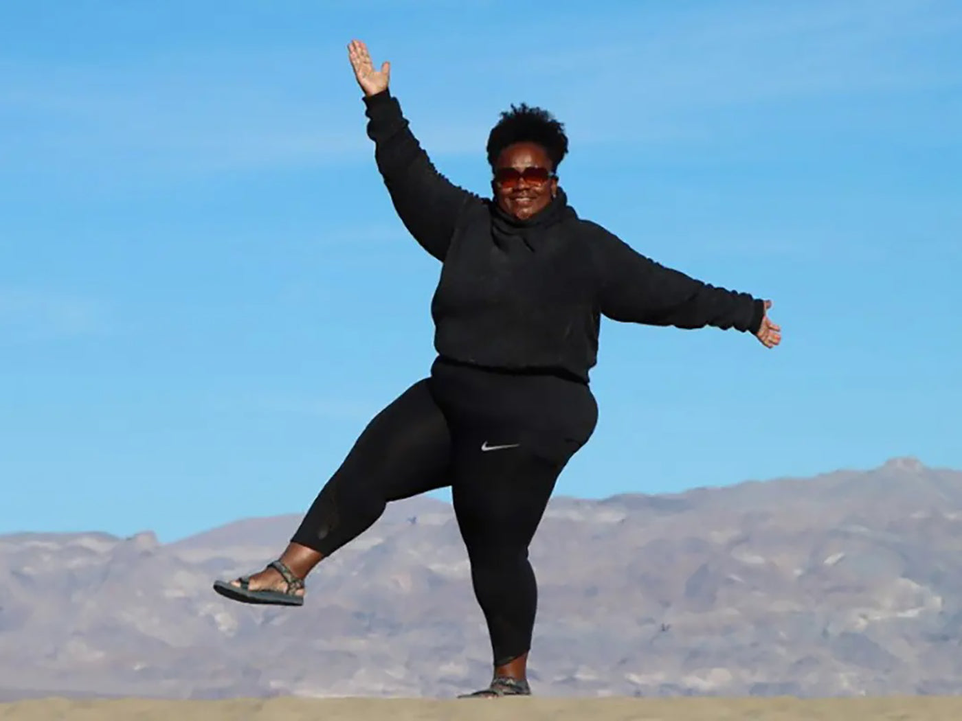 Woman posing with a blue sky in the background