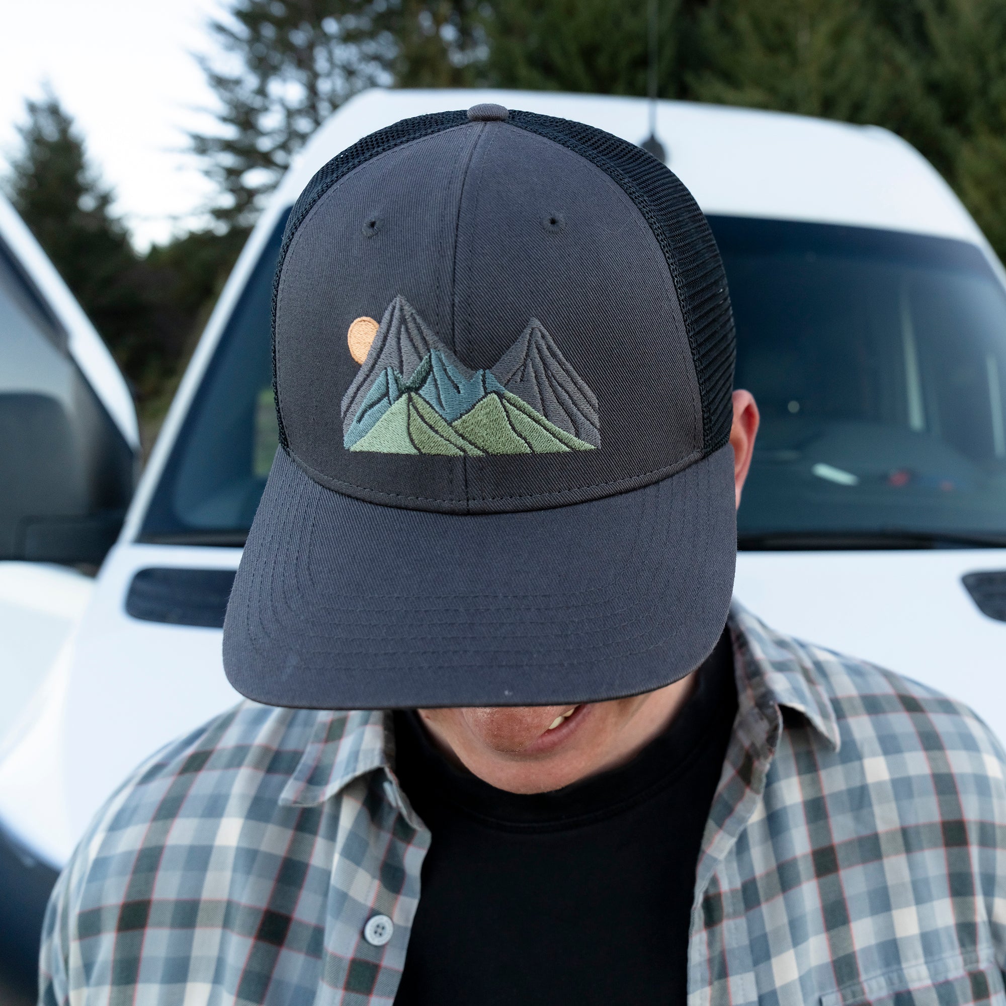 A man wearing a Sunday Afternoons Sunday Trucker in the Rising Crags color.