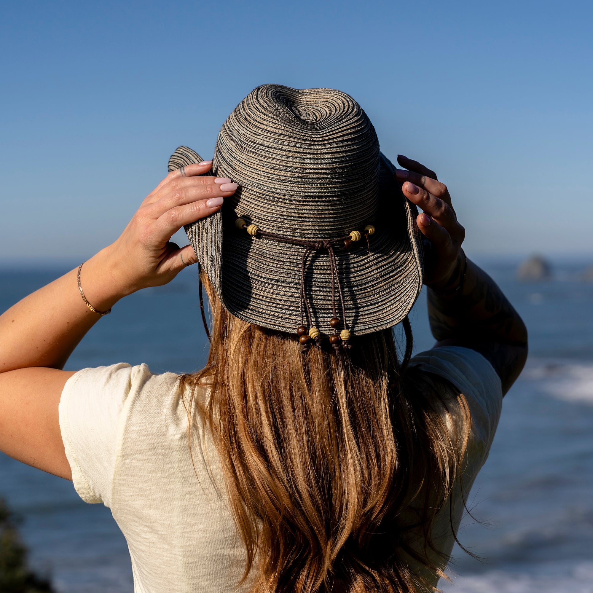 Woman turned away showing the back of a Sunday Afternoons Sunset Hat