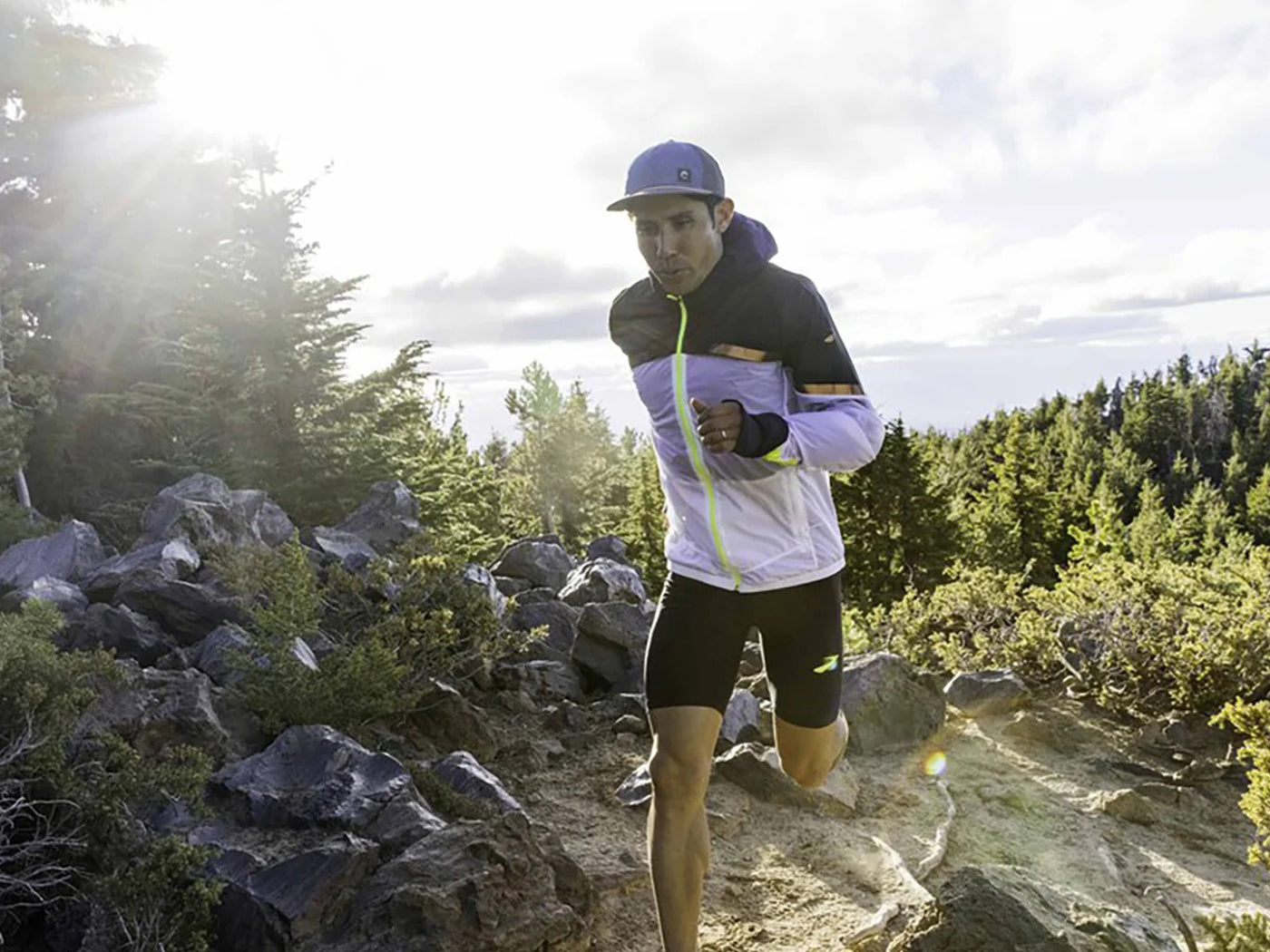 man running outdoors in the sun, wearing a Sunday Afternoons Vantage Point Trucker Hat