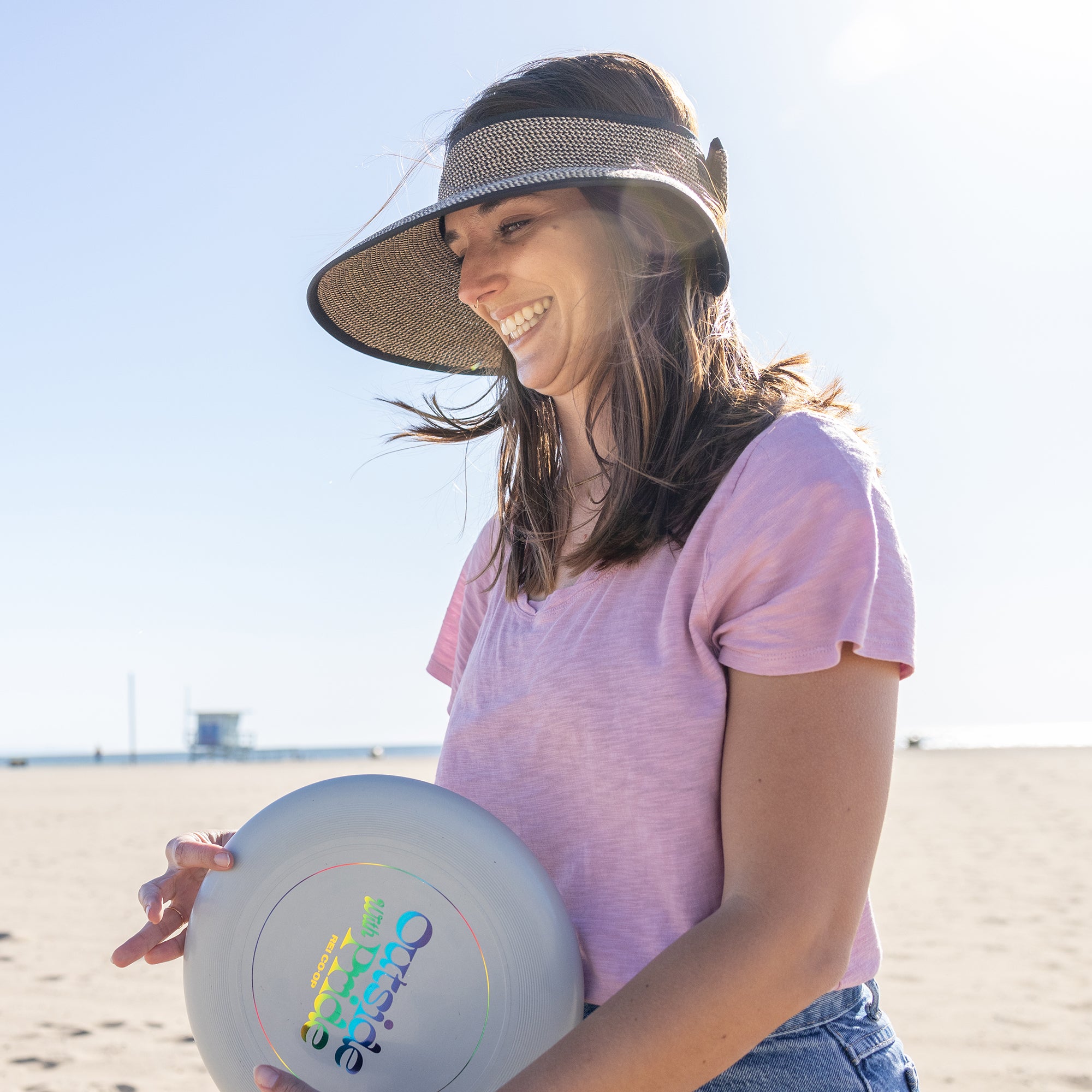 Woman on beach with visor
